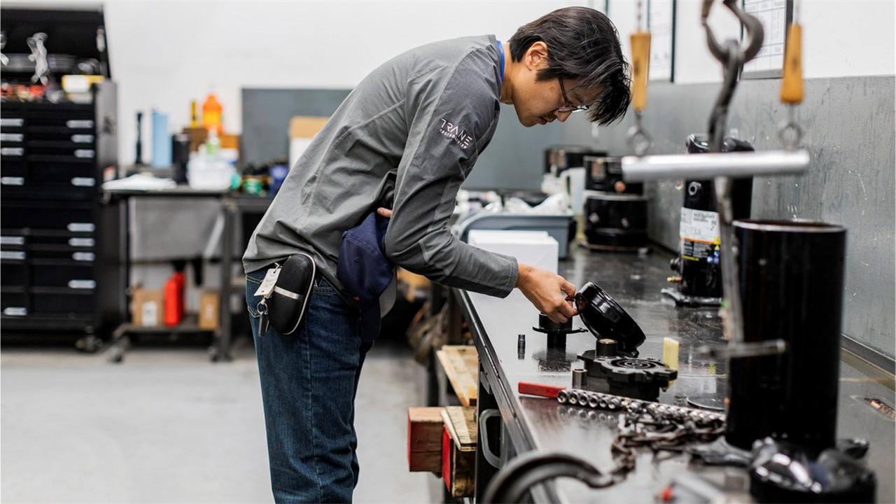 Participant during education session taking advantage of hands-on learning of HVACR equipment