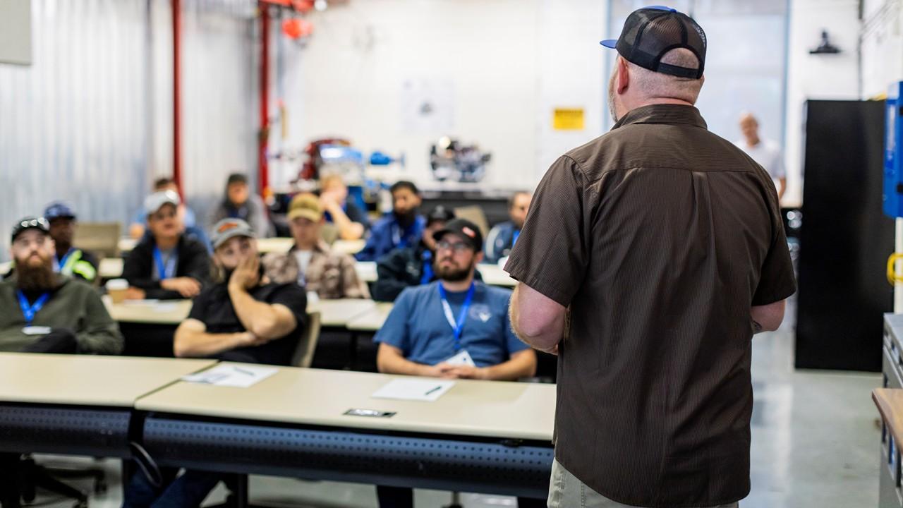 Speaker addressing HVACR apprentices during an education session on Industrial HVACR equiptment
