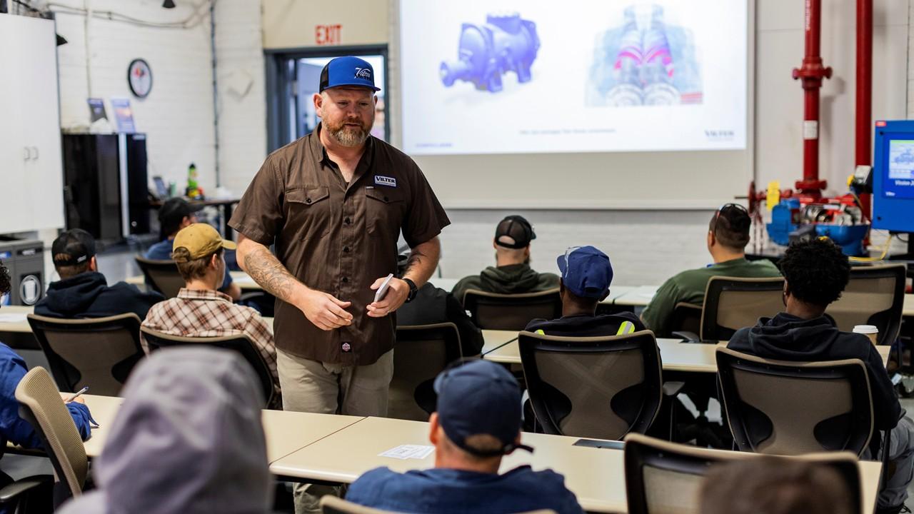 Classroom-style Vilter industrial compressors during technical training with seated apprentices